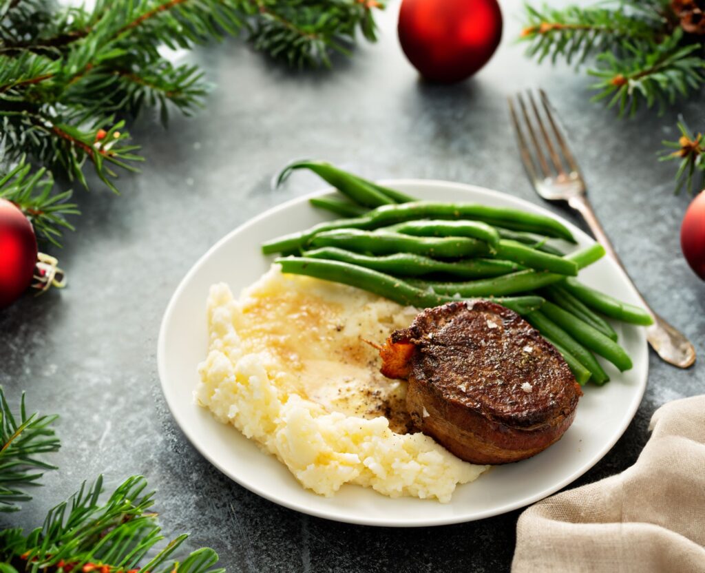 A roast dinner on a table with Christmas decorations