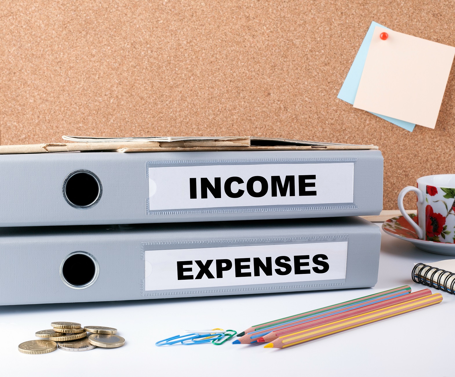 Income and Expenses folders on office desk