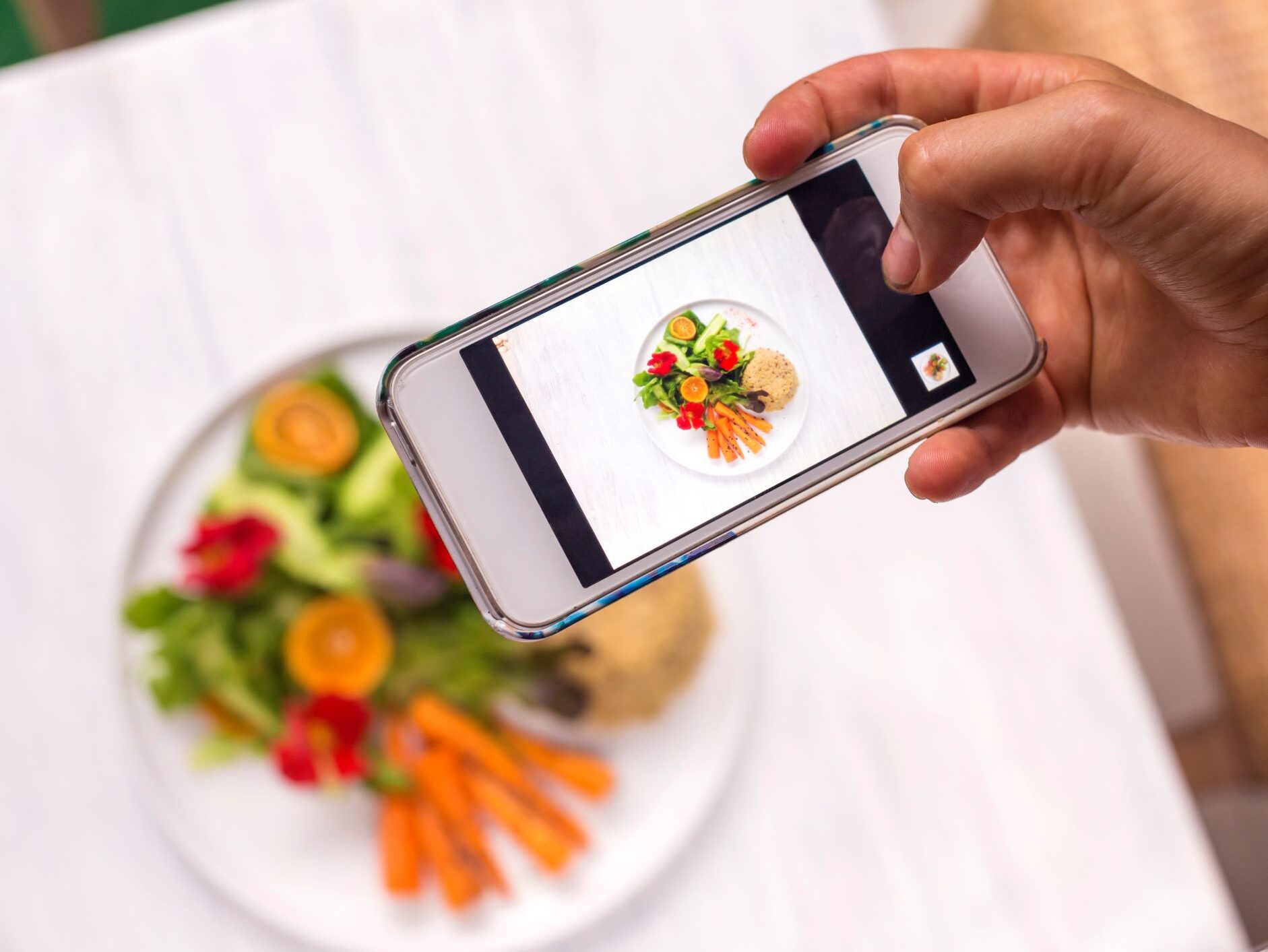 Chef taking a photo of a meal