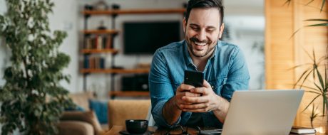 man text messaging over smart phone,