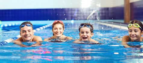 Family swims in a swimming pool